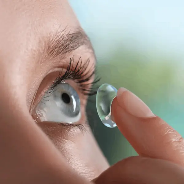 women putting contact lense close up shot